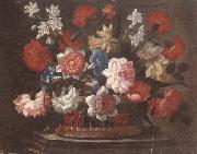 Still life of various flowers in a wicker basket,upon a stone ledge